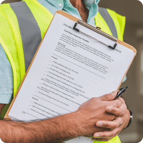 Technician holding clipboard during home energy inspection