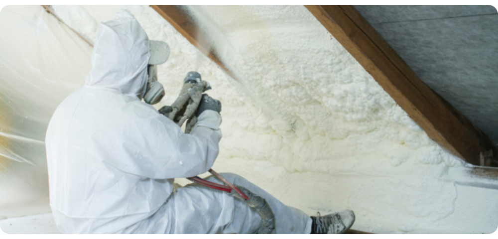 Builder spray foaming a roof